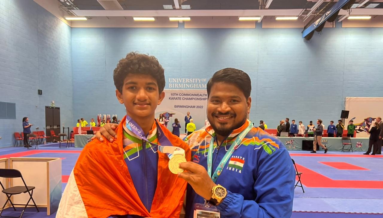 Karthik with his coach Keerthan Kondru after wining gold at the Commonwealth Games Championship. (Supplied)