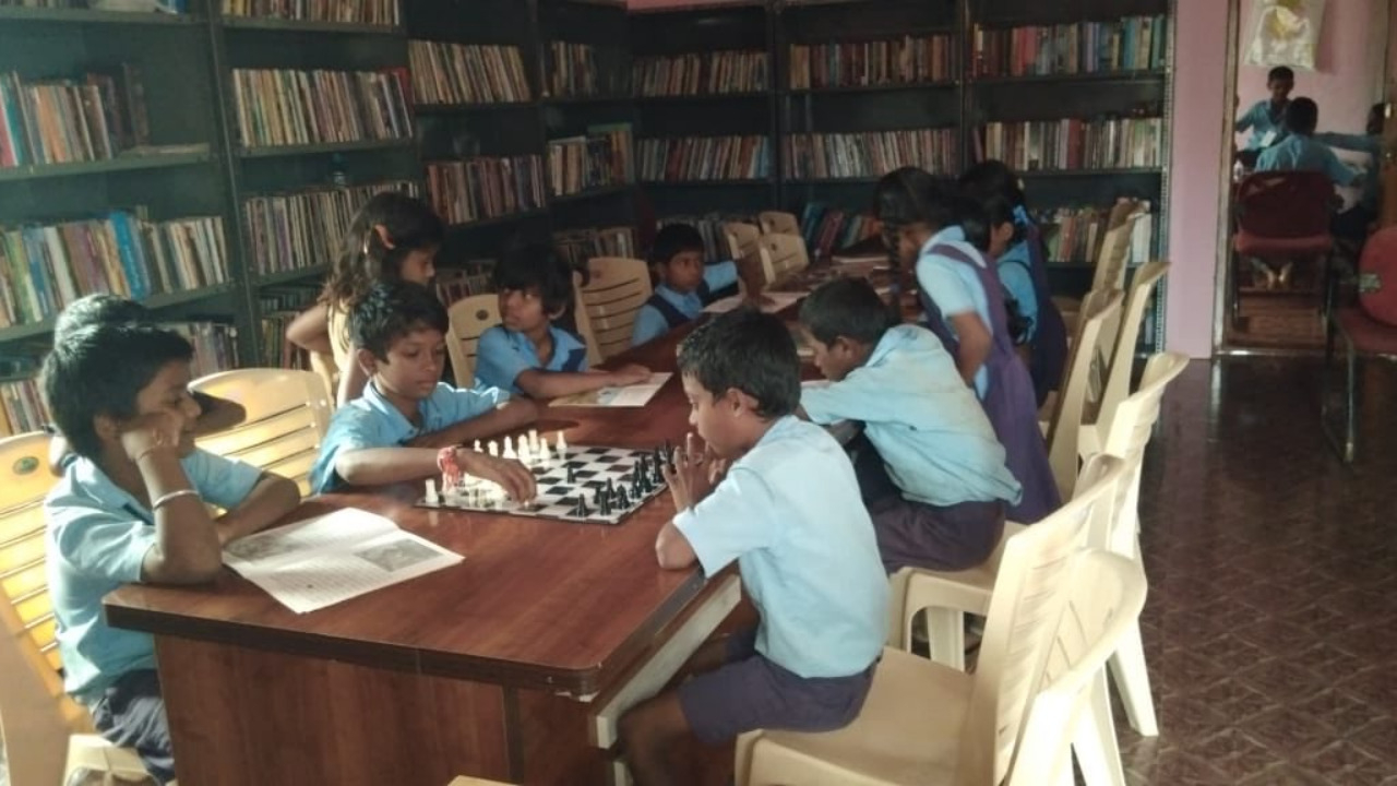 Karnataka rural libraries, children reading books and playing chess