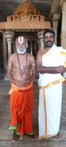 Madhusudhanan Kalaichelvan (right), the author of this article, now plays the role of brahma rakshasa in the play. On the left is the person who used to play the role of brahma rakshasa in the  play earlier; he still adorns the traditional mask but does not participate in the play, and sits behind the stage after his entry and introduction