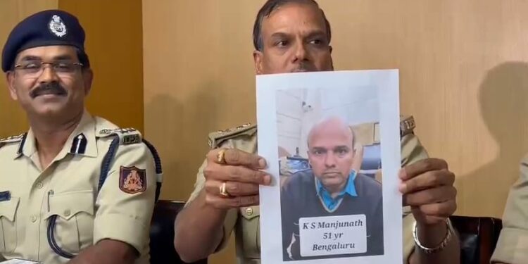 ADGP Law & Order Alok Kumar holding up a photo of Manjunath alias Santro Ravi.
