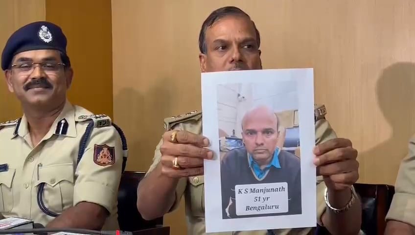 ADGP Law & Order Alok Kumar holding up a photo of Manjunath alias Santro Ravi.