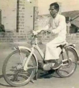 Jnana Yogashram seer Siddheshwara Swamiji riding an electric bicycle. (Supplied)
