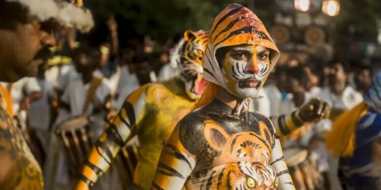 A 2016 photo of Rehana Fathima taking part in 'Puli Kali', a recreational folk tiger dance performed by men during the Onam festival in Thrissur. (Supplied)