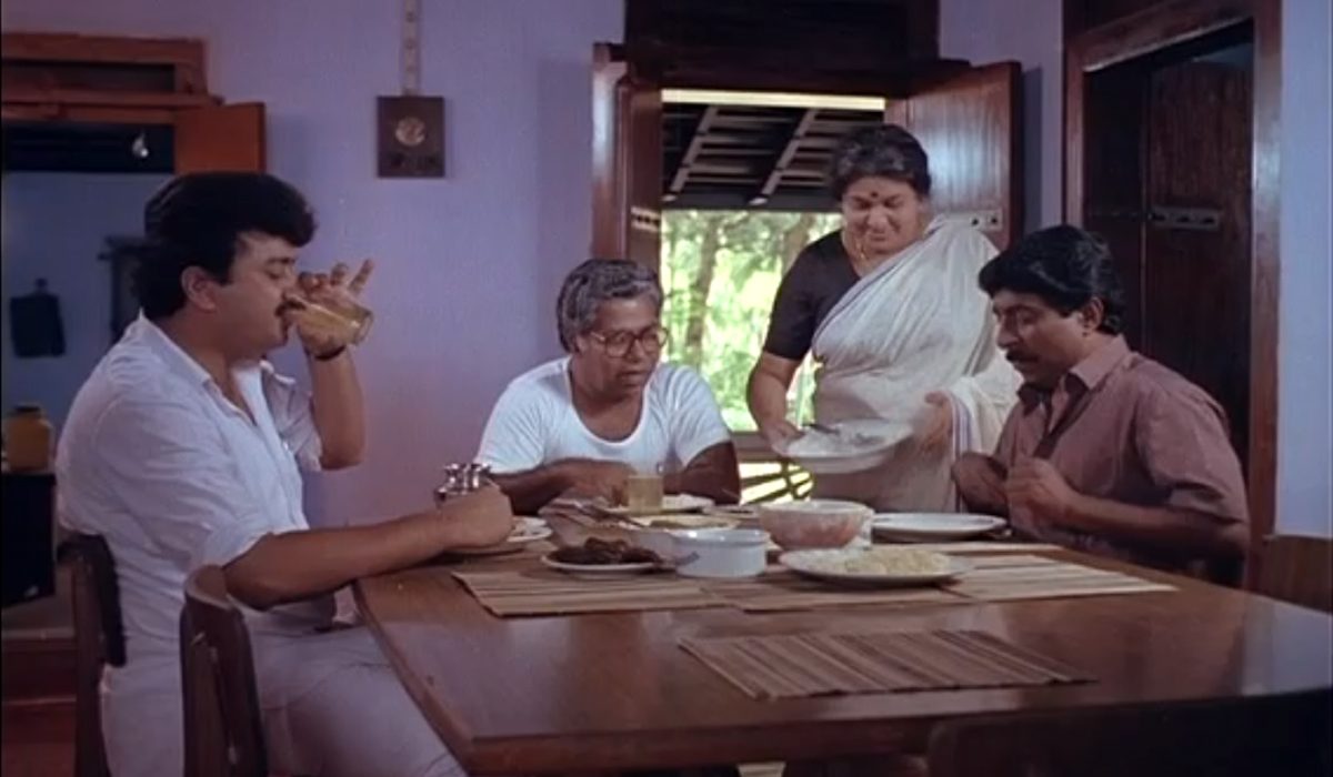 Scene from the movie Sandesam with Srinivasan, at right, playing the Communist with global sensibilities.