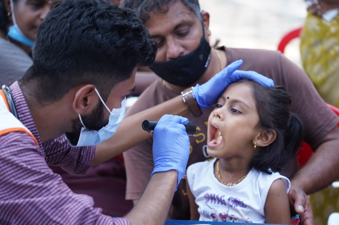 A doctor attached to the mobile unit of the health department checks a child at Vennala, Kochi, on Monday. (Facebook/District Collector)
