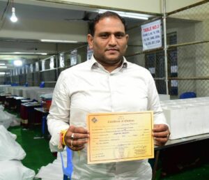 AP MLC election results - East Rayalaseema graduates' constituency winner Kancharla Srikanth Chowdhary with his certificate. (Supplied)