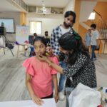 Children getting their face and hand painted at first Korean film fetsival in Hyderabad