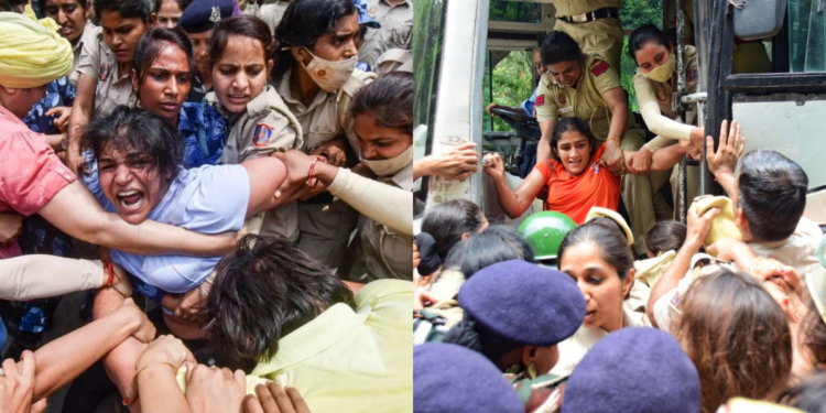 Wrestlers Sakshi Malik and Sangeeta Phogat being detained by the Delhi Police just a few kilometres away from the new Parliament building, where they were protesting, on 28 May. (Twitter)