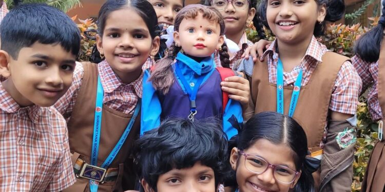 Students from a school in Sirsi, Karnataka, with Shiksha, a humanoid