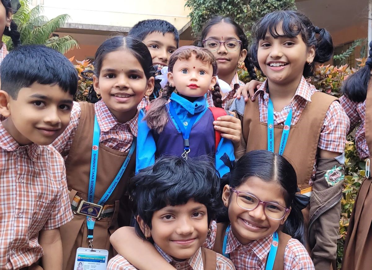 Students from a school in Sirsi, Karnataka, with Shiksha, a humanoid