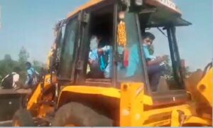 Students travelling to school in a JCB in Koppal