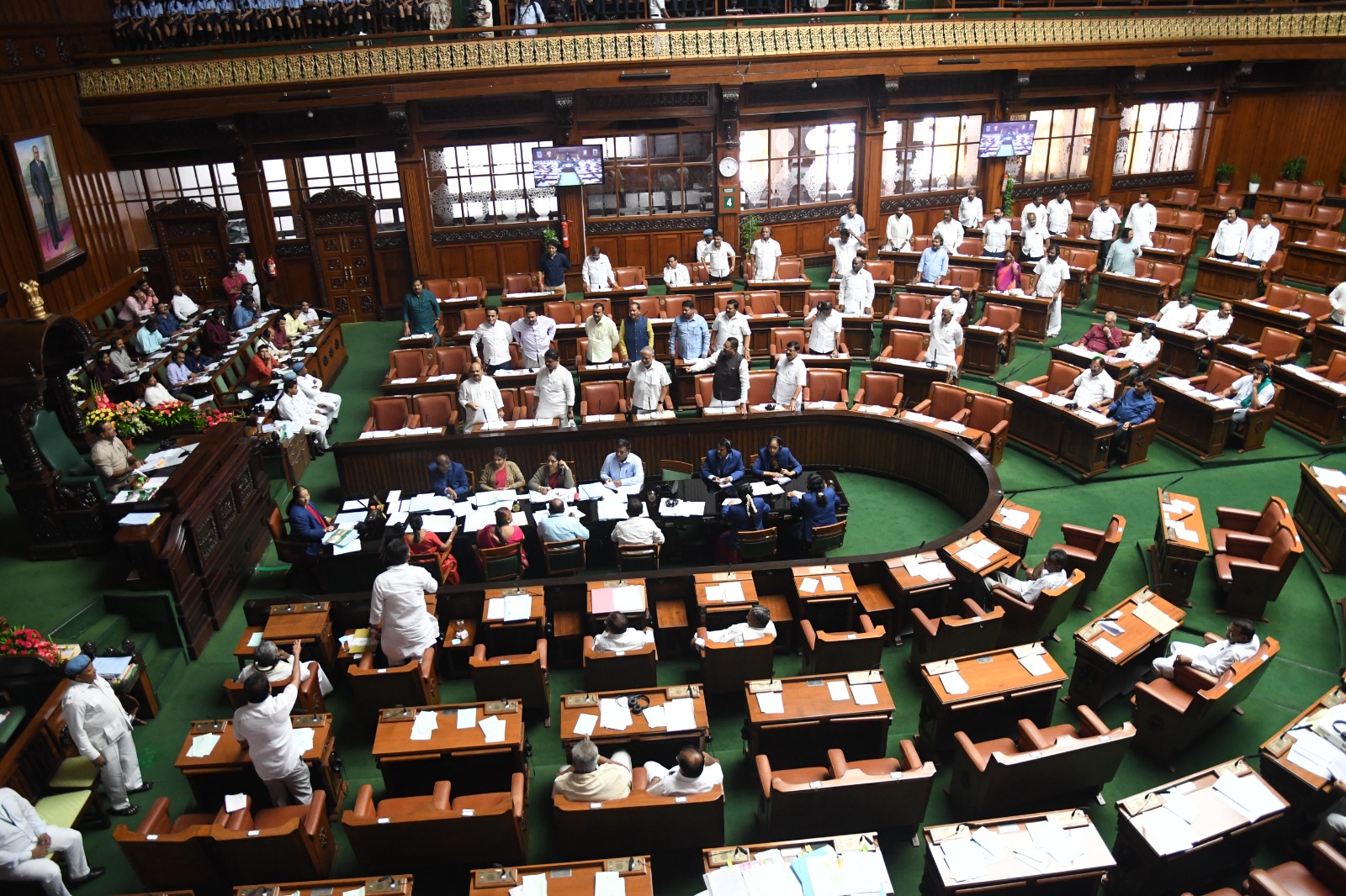 BJP MLAs staged protests inside the Legislative Assembly against the ruling government for delaying in implementing the five guarantees. (Supplied)