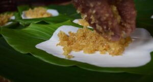 The coconut jaggery is spread on a bed of rice. 