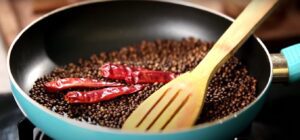 Dry roasting of spices for the gravy.