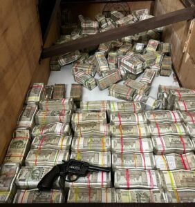 Drug money and a revolver were among the items seized during the arrest. (Supplied)