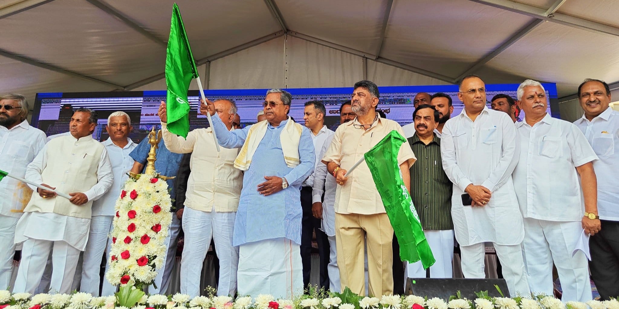 File photo of Chief Minister Siddaramaiah and Deputy Chief Minister DK Shivakumar, both holding green flags.