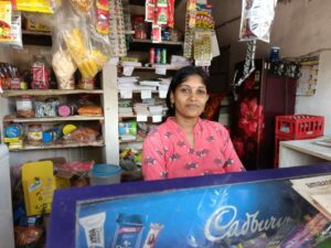 Teacher Sujana at her husband's shop. (Sumit Jha/South First)