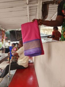 In Jangoan of Telangana, Srinidhi holds up the ‘Bathukamma’ saree given to her this year, disappointed. (Anusha Ravi Sood/ South First)