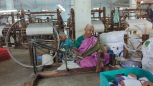 Image of woman weaving in the Dubbak handloom sector. 