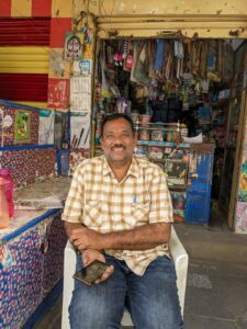 Raghu Nandan- a shop-owner in Alwal happy about area not submerging (Deepika Pasham/South First)