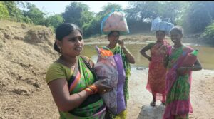 Rajeshwari (right) with the group of women crossing the stream. (Sumit Jha/South First)