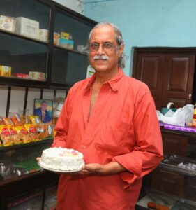 Premnath with the Ice cake, a signature item at Santha bakery. (Supplied)