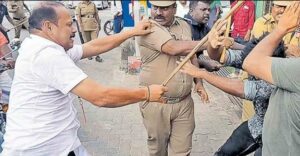 Gunman of Vijayan beating protestors with stick in Alapuzha. Photo: Supplied