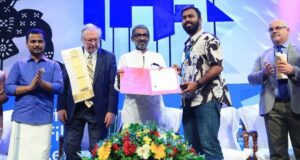 Fazil Razak receiving best debutant director award at IFFK Malayalam