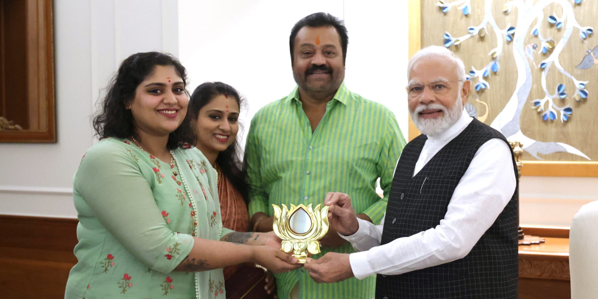 Bhagya presents a replica of BJP symbol to Modi in Delhi with Gopi and his wife Radhika Nair.