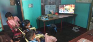 Children watching stories on TV in the library