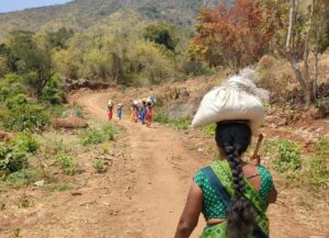 The group of women walking towards the village. 