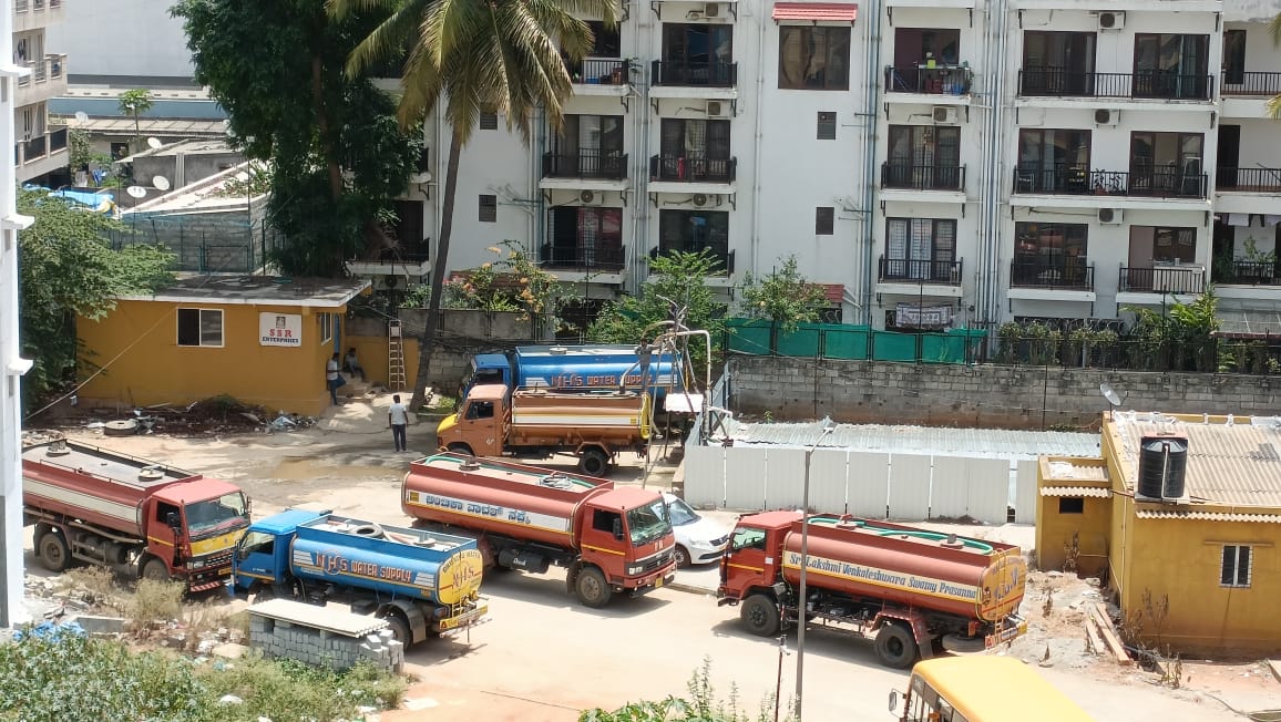 Water tankers waiting at a borewell point to fill and supply water in Bengaluru