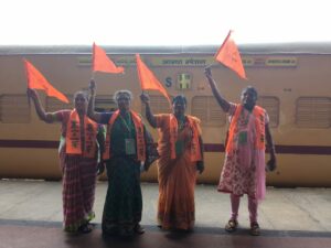 The women waving the saffron flag on the platform.