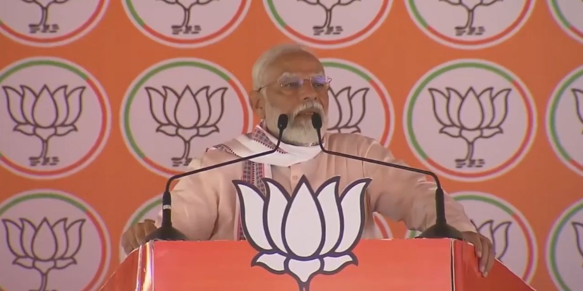 Modi speaking during a poll rally .