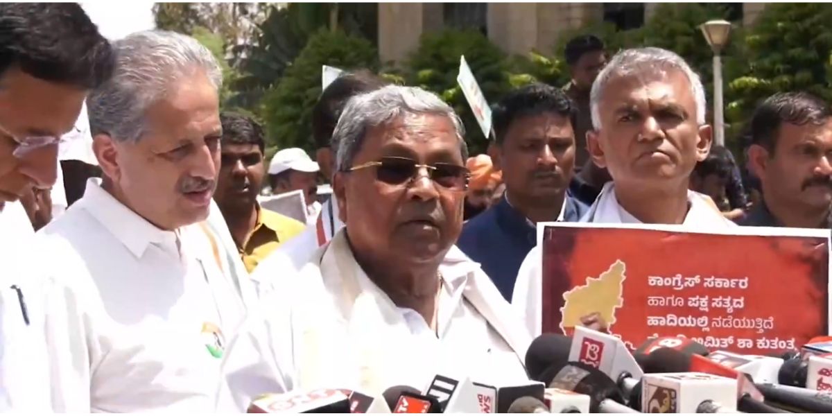 Siddaramaiah speaking to reporters during the protest.