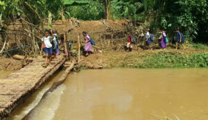 Children crossing the bamboo bridge. (South First)