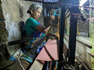A handloom worker weaving the saree. (South First)