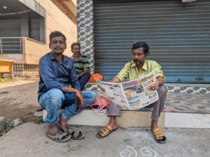 Paint workers share the 'news of the day' while waiting for work. (South First)